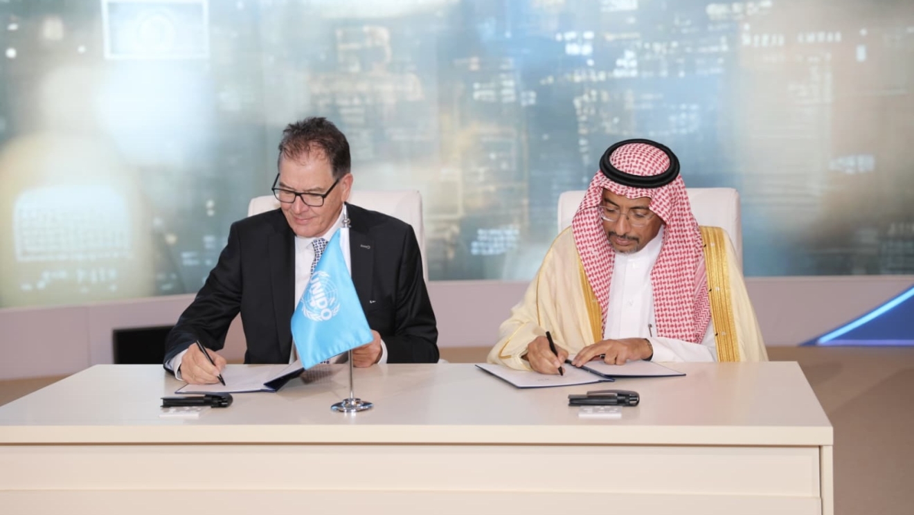 DG Gerd Müller and General Conference President Bandar Al-Khorayef sign to affirm Müller's reappointment as UNIDO Director General